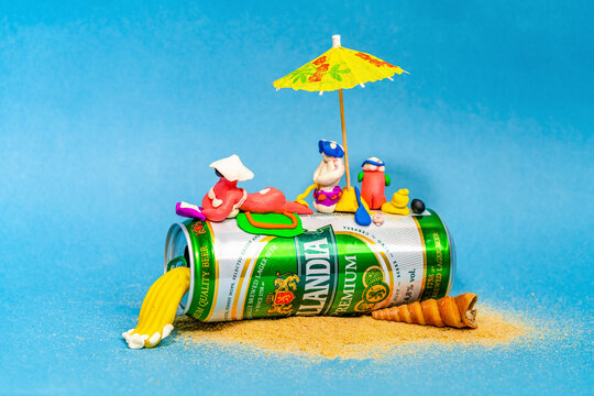 Rostov-on-Don, Russia - July 08, 2020: Funny plasticine men sunbathe lying on a can of beer. Dutch beer cen, Hollandia, Brewed in Holland, since 1758