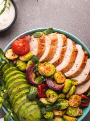 roasted sliced turkey, chicken, fillet with brussels sprouts, avocado, herbs, healthy food
