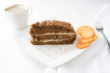 Slice of carrot cake and coffee on white background