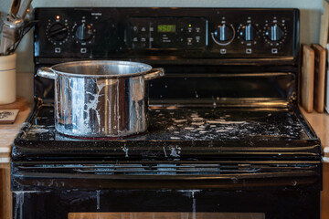 A DIY cooking project leaves a messy stove top in a home kitchen.