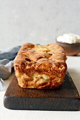 Pancake pie with meat and mushrooms on a gray background. Pancake cake in the form of bread. Slavic cuisine. Pancake pie with meat and mushrooms on a gray background, copy space. Shrovetide Maslenitsa