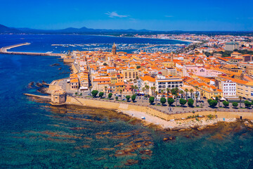 Aerial view over Alghero old town, cityscape Alghero view on a beautiful day with harbor and open sea in view. Alghero, Italy. Panoramic aerial view of Alghero, Sardinia, Italy. - obrazy, fototapety, plakaty