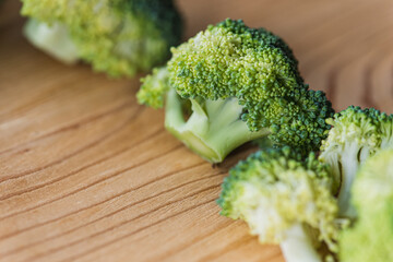 green broccoli on wooden background, top view, concept of healthy eating, food