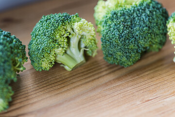 green broccoli on wooden background, top view, concept of healthy eating, food