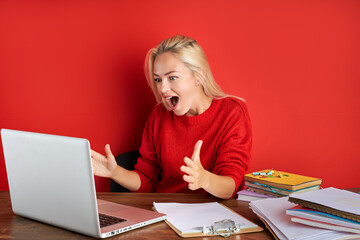 happy caucasian woman look at screen of laptop at work, smile, she has done whole work he need to do or get good results via mail