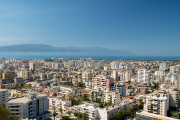 Fototapeta na wymiar Albania, Vlore, cityscape seen from Kuzum Baba hill. Aerial city view, city panorama of Vlore with the monument of the partisans