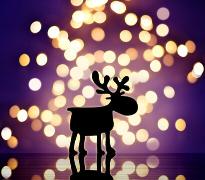 Magic christmas background with christmas lights and silhouette deer at night