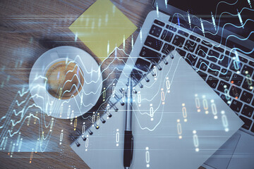 Double exposure of forex chart drawing over table background with computer. Concept of financial research and analysis. Top view.
