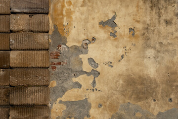 Background of old vintage dirty brick wall with peeling plaster