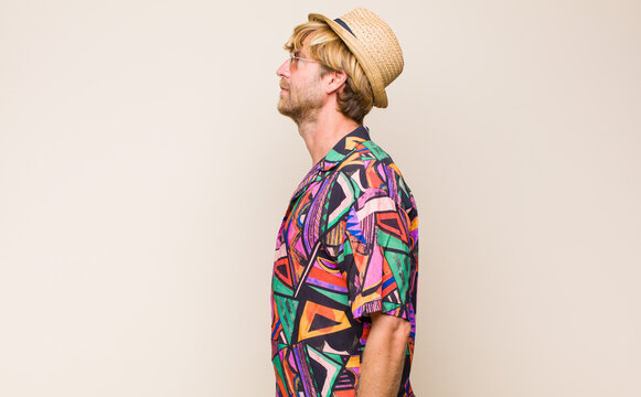 blonde adult traveller manon profile view looking to copy space ahead, thinking, imagining or daydreaming