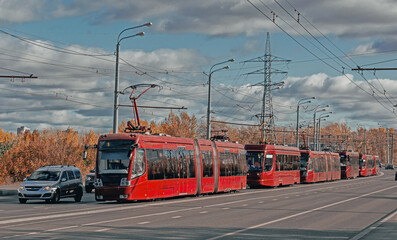 A lot of red modern city trams in Kazan. Public transportation concept. City background banner.