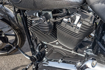 The engine of the motorcycle with chrome detailing.