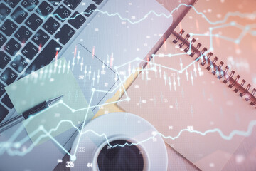 Stock market graph and top view computer on the table background. Double exposure. Concept of financial education.