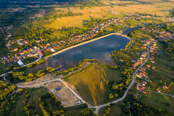 Beautiful Tismana lake and surrounding forest aerial panorama. Tismana, Romania.