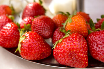 Ripe juicy strawberries are lying on a platter