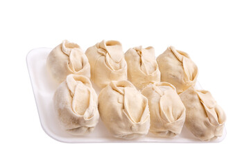 Frozen dumplings in a tray in rows on a white background