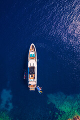 Yacht anchoring in crystal clear turquoise water in front of the tropical island, alternative...