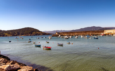Fototapeta premium VIew of colorful boats in the serene harbor of Puerto de Espasante, a village on the coast of the Cantabran sea in the Galicia region of Spain.