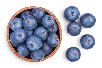fresh ripe blueberry in wooden bowl isolated on white background with clipping path . Top view. Flat lay pattern