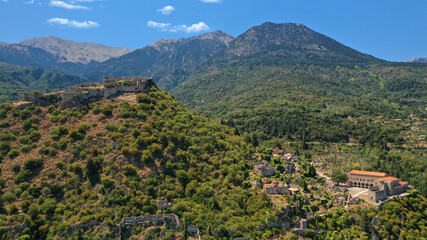 Obraz premium Aerial drone photo of medieval byzantine old city of Mystras featuring Monastery of Pantanassa, Temple of Agia Sofia and uphill castle of Mystras, Sparta, Peloponnese, Greece