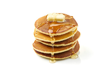 Stack of pancakes with butter and honey on white