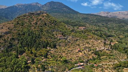 Aerial drone photo of medieval byzantine old city of Mystras featuring Monastery of Pantanassa, Temple of Agia Sofia and uphill castle of Mystras, Sparta, Peloponnese, Greece