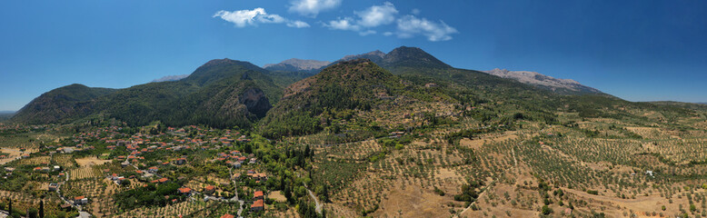 Obraz premium Aerial drone photo of medieval byzantine old city of Mystras featuring Monastery of Pantanassa, Temple of Agia Sofia and uphill castle of Mystras, Sparta, Peloponnese, Greece