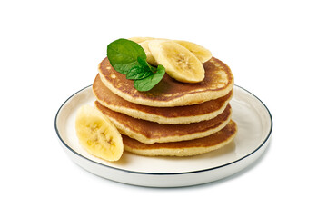 Stack of pancakes with banana and mint leaf on dish over white
