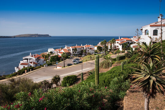 panoramic view of a white village in front of the mediterranean sea in fornells menorca