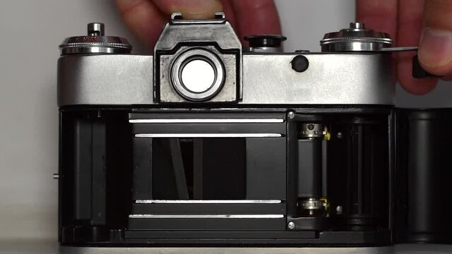 Working of a broken shutter of an old film camera, slow motion.