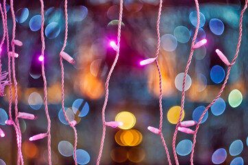 Chrismas pink lights on colored background with bokeh