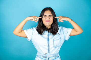 Young woman with hand on head for pain in head because stress. Suffering migraine.