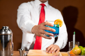 Barman preparing drink with shaker