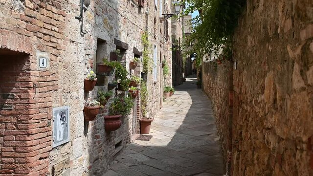 Colle di Val d'Elsa, Tuscany, Italy. August 2020. Tilt footage in an alley in the historic center: enchanting glimpses of medieval times full of charm.