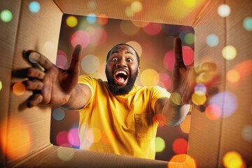 Happy boy receives Christmas gift. happy and surprised expression.