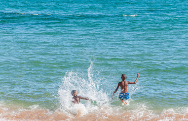 two boys playing on the beach