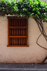 Old window with handmade wooden balcony