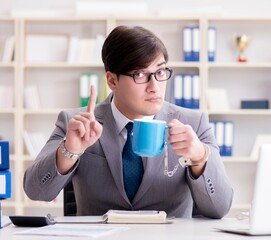 Businessman chained with handcuffs to his coffee