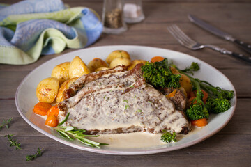 Roast beef steak fillets with creamy Gorgonzola cheese dressing and vegetables on plate. Horizontal...