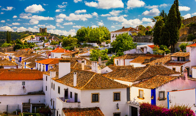Historic walled town of Obidos, near Lisbon, Portugal. Beautiful streets of Obidos Medieval Town, Portugal. Street view of medieval fortress in Obidos. Portugal.