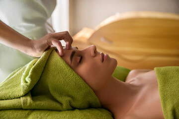 Face massage.  Close-up of young woman getting spa massage treatment at beauty spa salon.