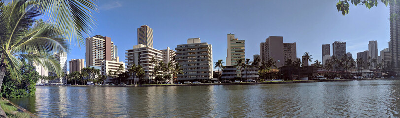 Fototapeta na wymiar Ala Wai Canal, hotels, Condos, and Coconut trees