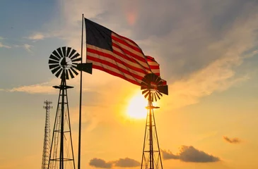 Fotobehang Oranje windmill and American flag at sunset  © Lance