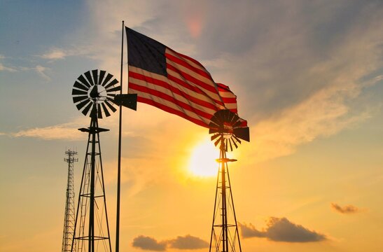 windmill and American flag at sunset