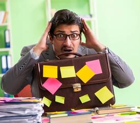Businessman unhappy with many conflicting priorities sitting in