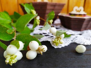 Items of Russian traditional national craft lace napkin wooden boxes tray with painting white berries on a twig
