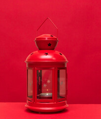 christmas lantern with candle on red background