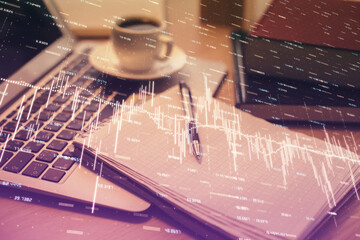Double exposure of forex chart drawing and desktop with coffee and items on table background....