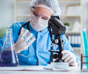 The female scientist researcher doing experiments in laboratory