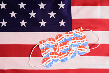 Face mask of a proud voter during the democratic elections in the USA with stickers on the...
